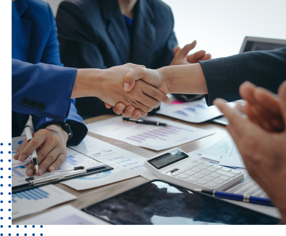 Business handshake over documents and calculator.