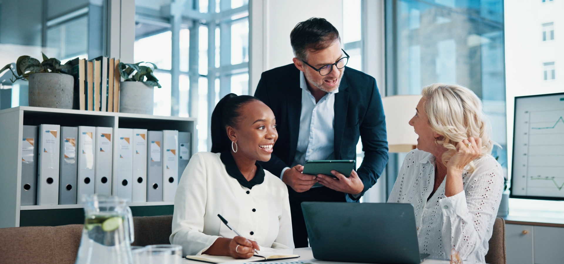 Office workers collaborating at a desk.